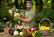 © Volodymyr - Farmer harvesting fresh vegetables in rural garden. 40s Man checking pumpkins, carrots, corn, broccoli, peppers, tomatoes and potatoes. Agronomist collecting nutritious produce on organic farm.