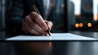 © Cieasha - Close up of a hand signing a document with a fountain pen in an office setting at night