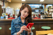 © leungchopan - Woman use phone to order food restaurant