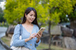 © leungchopan - Woman use phone at park outdoors