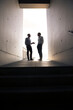 © Westend61 - Two businessmen talking in a passageway