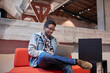 © Westend61 - Young man working in creative start-up company, using laptop