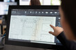 © DC Studio - Female creative designer sketching architectural floor layout on digital device, preparing for new construction project. Closeup of woman architect pointing at screen, cross checking building designs.