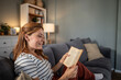 © Migma_Agency - Woman relaxing at home reading an interesting book