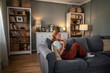 © Migma_Agency - Young woman relaxing on sofa reading favorite book at home