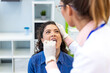 © Graphicroyalty - Throat exam close up. Oral infection check, People with viral disease problem, Healthcare And Medicine concept. Close-up of doctor in gloves examining woman throat with a wooden tongue depressor.