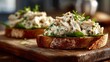 © fivan - Chicken salad on toasted sourdough, rustic cutting board, natural side light, casual lunch scene