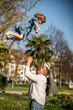 © ADDICTIVE STOCK - Father playing with child in park on sunny day