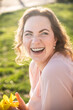 © ADDICTIVE STOCK - Woman enjoying spring sunshine with a bright smile