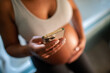 © Davor - Pregnant woman using smartphone at home