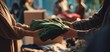 © Marta B - The Green Sweater Being Handed Over Between Two People at a Market