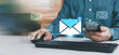 © ภัทรชัย รัตนชัยวงค์ - Business email notification concept with envelope icon over smartphone and computer keyboard. Digital communication, online messaging, inbox alert, marketing automation corporate technology network.