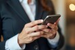 © Vera - A Businesswoman Completing an Online Survey on Her Smartphone with a Close-up View of Her Hand