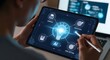 © MasoomBox - Man holding tablet with futuristic interface and light bulb design