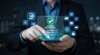 © mohsin - Businessman verifying successful digital transaction on smartphone with security icons