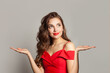 © artmim - Healthy model woman holding empty open palm hand and looking up on white background