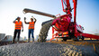 © Perecciv - Pouring fresh concrete at a construction site, concrete pump, workers in personal protective equipment,