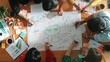 © InfiniteFlow - Group of business people writing and making mind map to brainstorming marketing idea at meeting. Top aerial view of investors sharing plan or strategy by using sticky notes and marker. Convocation.