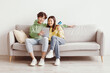© Prostock-studio - Millennial Asian couple with credit card and digital tablet sitting on sofa, ordering goods on internet, buying things in web store at home, copy space. Online shopping, remote banking concept