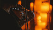 © VeNN - Close-up of a violinist performing in a dark, intimate setting. The musician is silhouetted, lit by a warm, golden glow from blurred candlelight, creating a moody and atmospheric bokeh effect