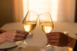 © kieferpix - Couple Toasting with White Wine Glasses at Romantic Candlelight Dinner