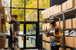 © DC Studio - Black male staff in coveralls working with shelving units and packaging supplies, ensuring smooth shipment service for e-commerce operations and small business delivery operations.