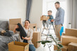 © Serhii - Happy family moving to new home unpacking cardboard boxes
