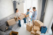 © Serhii - Family moving to new home unpacking cardboard boxes