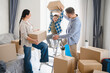 © Serhii - Family moving into new home with cardboard boxes