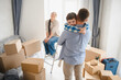 © Serhii - Family moving to new home embracing in room