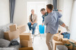 © Serhii - Family celebrating moving into new home with playing son