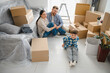 © Serhii - Family moving to new home with cardboard boxes