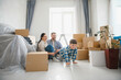 © Serhii - Family enjoying new home moving day with boxes