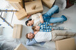 © Serhii - Family relaxing on floor after moving to new home