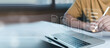 © ภัทรชัย รัตนชัยวงค์ - Businessman signing digital contract on laptop with virtual document checklist interface. E-signature technology, online agreement approval, paperless workflow and business compliance concept.