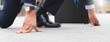 © Pormezz - Businessman set in start running position prepare to fight in business race.