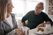 © BuyoutReese09/peopleimages.com - Conversation, smile and senior couple with breakfast and coffee in home with bonding. love and connection. Happy, talk and elderly people for eating morning snack with warm beverage together in house