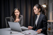 © Apichat - Businesswomen collaborating on financial data work late in office
