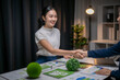 © Apichat - Business partners shaking hands on esg sustainability project