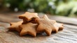 © Emma - Freshly baked gingerbread cookies shaped like stars on a wooden table