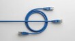 © Nataly - Blue Ethernet cable coiled on white background creating circular shape. Ethernet cable with RJ45 connectors provides high speed data connection for network infrastructure.