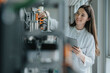 © Westend61 - Smiling female scientist holding digital tablet inventing machinery in laboratory