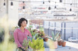 © Westend61 - Smiling woman standing in her rooftop garden
