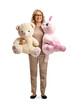 © Ljupco Smokovski - Smiling mature woman holding a large teddy bear and a pink unicorn plush toy