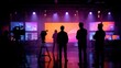 © BeatFlow - Silhouettes of people in a modern studio with large screens and cameras, preparing for broadcast