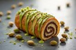 © Vadym - Pistachio roll with chocolate filling. Sweet pastry with green glaze and nuts. Delicious baked good for breakfast or snack. Artisanal creation.