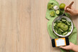 © Pixel-Shot - Woman using mobile phone with meal plan and healthy food on brown wooden background, top view