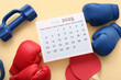 © Pixel-Shot - Composition with calendar and sports equipment on color background