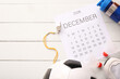 © Pixel-Shot - Composition with calendar and different sports equipment on light wooden background