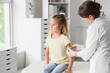 © Pixel-Shot - Female doctor applying patch on little girl's arm after vaccination in clinic